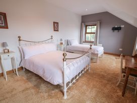A bedroom with a double bed and single bed at Ard Na Mara Drung near Quigley's Point, County Donegal