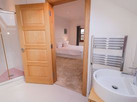 A bathroom with a shower and sink leading to a bedroom at Ard Na Mara Drung near Quigley's Point, County Donegal