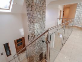 A hallway with stone wall and glass railing at Ard Na Mara Drung near Quigley's Point, County Donegal