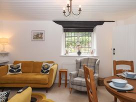 A living room with a sofa and dining table at 2 New Mill Cottages North Bovey