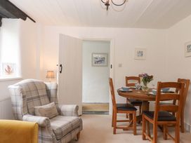 A dining room with a table and chairs at 2 New Mill Cottages North Bovey