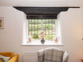 A living room with a window and decorative items at 2 New Mill Cottages North Bovey