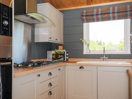 A kitchen with a gas stove microwave sink and window at 17 Meadow Retreat in Dobwalls