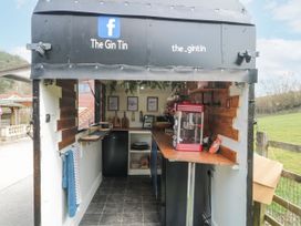 A small outdoor bar setup with wooden counters and a popcorn machine at The Gin Tin Camerton near Timsbury