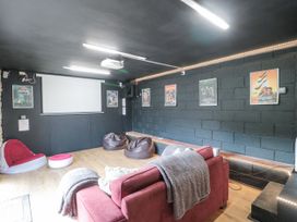 A home theater room with a projector screen bean bag chairs and a sofa at Bell tent 3 in Camerton near Timsbury