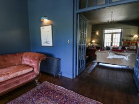 A living room with a sofa and radiator at Glanrannell Park House in Llanwrda