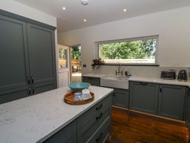 A kitchen with cabinets and countertop at Glanrannell Park House in Llanwrda