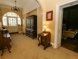 A hallway with a cabinet and lamp at Glanrannell Park House, Llanwrda