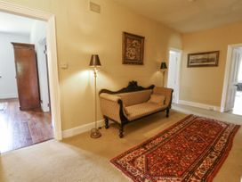 A hallway with a sofa and a lamp at Glanrannell Park House in Llanwrda
