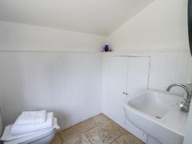 A bathroom with a toilet and sink at Glanrannell Park House in Llanwrda