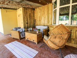 An outdoor seating area with a sofa and coffee table at Glanrannell Park House Llanwrda