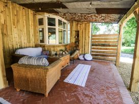 An outdoor living area with a sofa and armchair at Glanrannell Park House Llanwrda