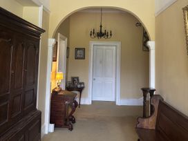 A hallway with a door and furniture at Glanrannell Park House Crugybar near Brechfa