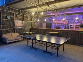 A recreational area with a ping pong table and a bar at The Retreat at Glanrannell Park House in Llansawel