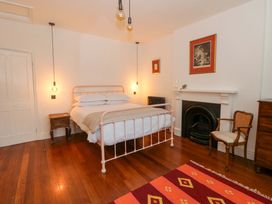 A bedroom with a bed and a fireplace at The Retreat at Glanrannell Park House in Llansawel