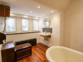 A bathroom featuring a bathtub and sink at The Retreat at Glanrannell Park House, Llansawel