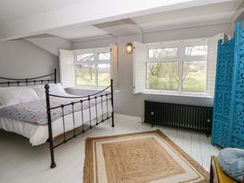 A bedroom with a bed and window at The Retreat at Glanrannell Park House, Llansawel