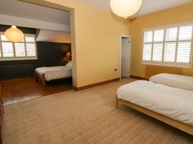 A bedroom with beds and lamps at The Retreat at Glanrannell Park House, Llansawel