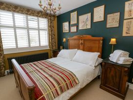 A bedroom with a bed and wall decor at The Retreat at Glanrannell Park House in Llansawel
