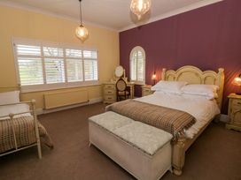 A bedroom with a double bed and a single bed at The Retreat at Glanrannell Park House in Llansawel