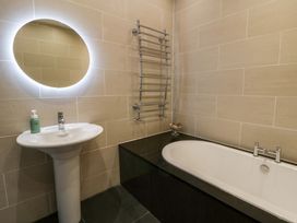 A bathroom with a sink and bathtub at The Retreat at Glanrannell Park House in Llansawel