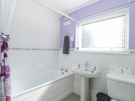 A bathroom with a bathtub sink toilet window and towel at Lighthouse View in Winterton-On-Sea