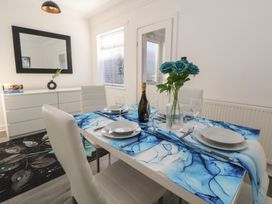 A dining room with a table set for dinner at Anfield Stadium House Liverpool