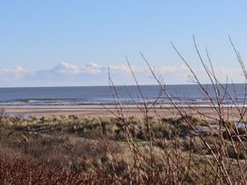 A beach view with dunes and water at Seafield Granary Alnmouth