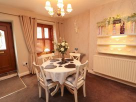 A dining room with a table and chairs at Beckside Cottage in Penrith