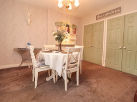 A dining room with a table and chairs at Beckside Cottage Penrith