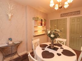 A dining room with a table and chairs at Beckside Cottage in Penrith
