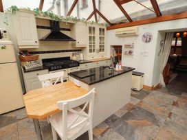 A kitchen with a large island and cabinets at Beckside Cottage in Penrith