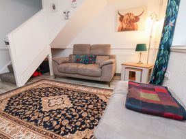 A living room with a sofa and rug at Wayside Farm Dairy Cottage Cloughton near Burniston