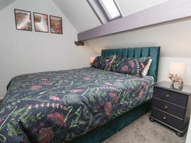 A bedroom with a bed and nightstand at Wayside Farm Dairy Cottage Cloughton near Burniston