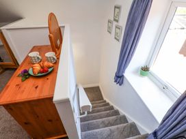 A stairwell with a table holding cups and croissants at Wayside Farm Stable Cottage in Cloughton near Burniston