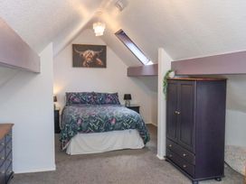 A bedroom with a bed and wardrobe at Wayside Farm Stable Cottage Cloughton near Burniston