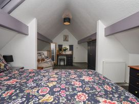 A bedroom with a bed and furniture at Wayside Farm Stable Cottage Cloughton near Burniston
