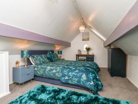 A bedroom with a bed and bedside table at Wayside Farm Cart Cottage Cloughton near Burniston