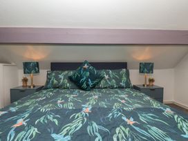 A bedroom with a bed and bedside lamps at Wayside Farm Cart Cottage Cloughton near Burniston