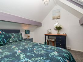 A bedroom with a bed and dresser at Wayside Farm Cart Cottage in Cloughton near Burniston