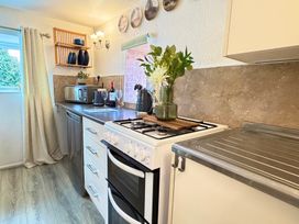A kitchen with appliances and countertop at Wayside Farm Cart Cottage Cloughton near Burniston