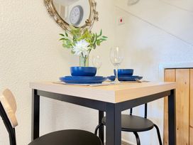 A dining table with plates and glasses at Wayside Farm Cart Cottage Cloughton near Burniston