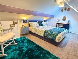 A bedroom with a bed and desk at Wayside Farm Cart Cottage Cloughton near Burniston