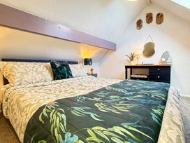 A bedroom with a bed and side table at Wayside Farm Cart Cottage Cloughton near Burniston
