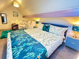 A bedroom with a bed and bedside tables at Wayside Farm Cart Cottage Cloughton near Burniston