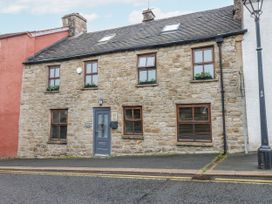A stone house with windows and a front door at Mill Race House in Alston