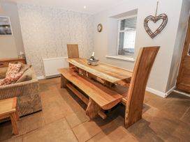 A dining room with a wooden table and seating at Mill Race House in Alston