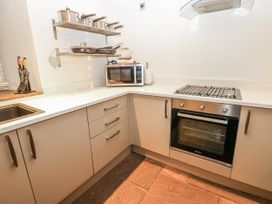 A kitchen with a microwave and oven at Mill Race House Alston