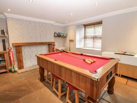 A games room with a pool table and bookshelf at Mill Race House Alston