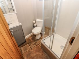 A bathroom with a shower, toilet and sink at Mill Race House in Alston